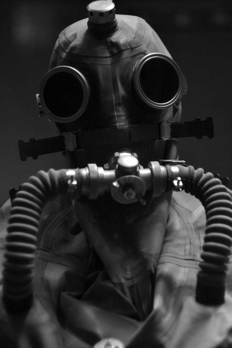 Black and white portrait of a person in a gas mask symbolizing protection from danger and toxic elements.