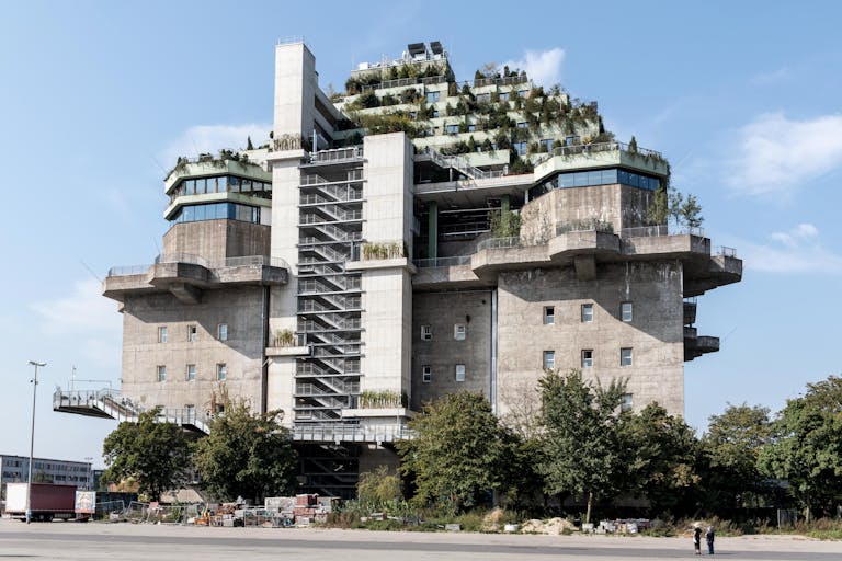 Modern sustainable building with greenery on rooftop in Hamburg.